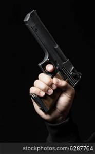 male hand with gun isolated on black background