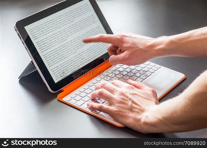 Male hands and white orange convertible laptop