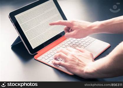 Male hands and white orange convertible laptop