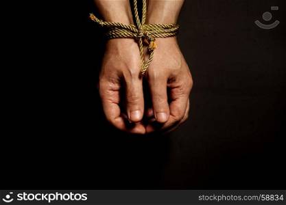 Male hands bound with rope.Addiction concept.