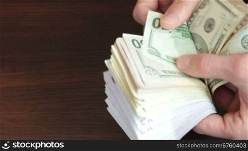 Male Hands Counting Euro and Dollar Cash Money