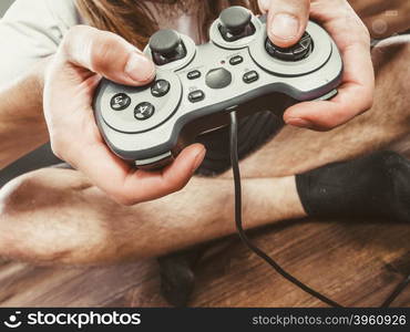 Male hands holding joystick pad. Playing games concept. Part body man with joystick play game on console playstation. Male hands holding grey pad.