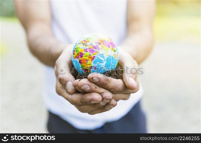 male hands holding small globe