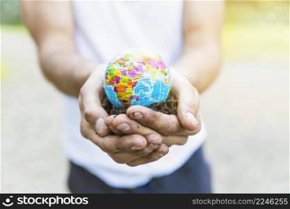 male hands holding small globe