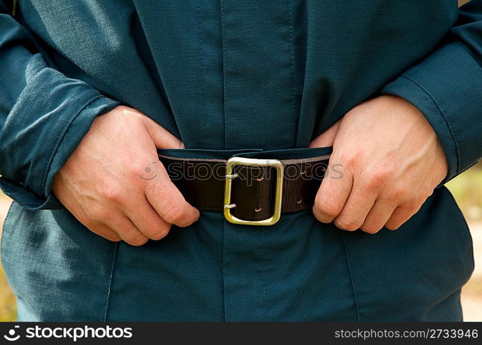 male hands on the leather belt