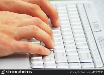 male hands typing on a laptop