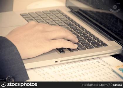 male hands typing on computer keyboard.Film style color effect