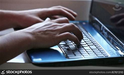 Male hands typing on notebook keyboard