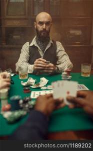 Male hands with cards, poker player in suit on backgroud, casino, risk addiction. Games of chance. Man leisures in gambling house, gaming table with green cloth. Male hands with cards, poker, games of chance