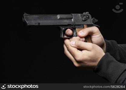 male hands with gun isolated on black background