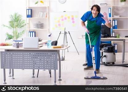 Male handsome professional cleaner working in the office 