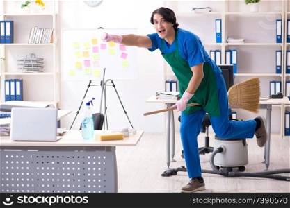 Male handsome professional cleaner working in the office 