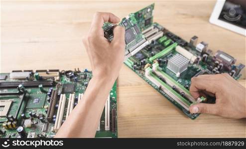male hardware engineer inserting circuit board memory slot . Resolution and high quality beautiful photo. male hardware engineer inserting circuit board memory slot . High quality and resolution beautiful photo concept