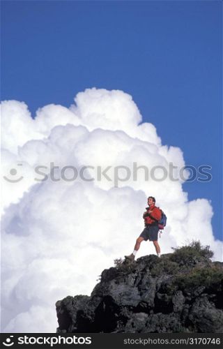 Male Hiker Standing Triumphantly On A Mountain Peak