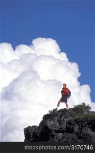 Male Hiker Standing Triumphantly On A Mountain Peak