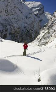 Male hiker walking in a snow covered landscape, Annapurna Range, Himalayas, Nepal