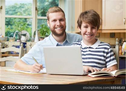 Male Home Tutor Helping Boy With Studies