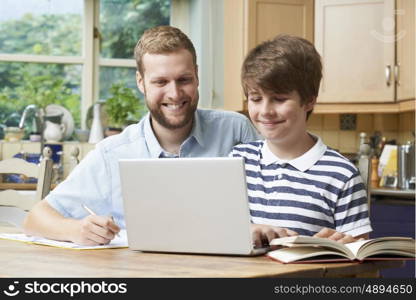 Male Home Tutor Helping Boy With Studies