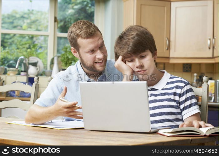 Male Home Tutor Helping Boy With Studies