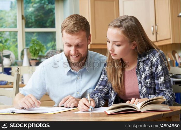 Male Home Tutor Helping Teenage Girl With Studies