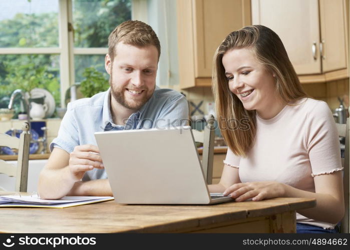 Male Home Tutor Helping Teenage Girl With Studies