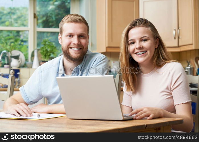 Male Home Tutor Helping Teenage Girl With Studies