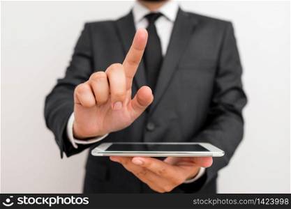 Male human wear formal clothes present presentation use hi tech smartphone. Male human wear formal working clothes presenting presentation of high technology smartphone device. Man dressed in work suit plus tie showing small mobile hi tech phone