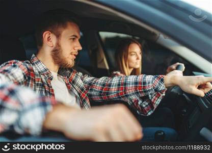 Male instructor and woman student, driving lesson, car school concept. Test for beginner. Male instructor and woman student, driving lesson