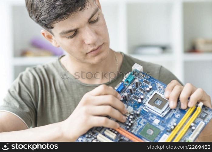 male it technician repairing motherboard