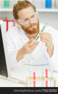 male lab worker using a pipette