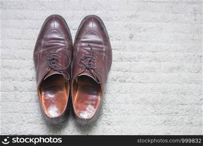 Male leather shoes on carpet, brown, top view,