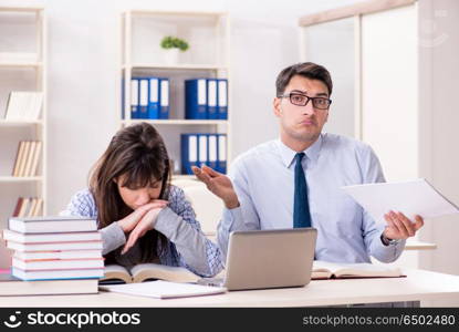 Male lecturer giving lecture to female student