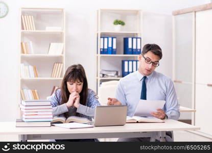 Male lecturer giving lecture to female student