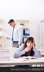 Male lecturer giving lecture to female student