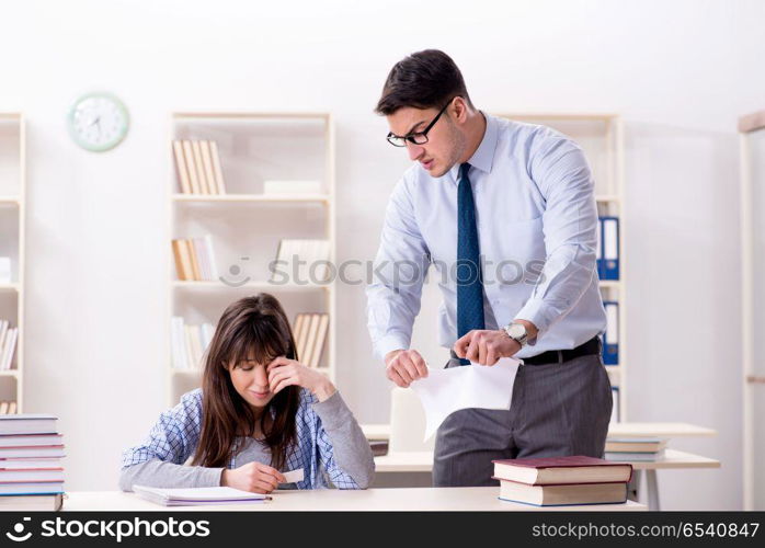 Male lecturer giving lecture to female student