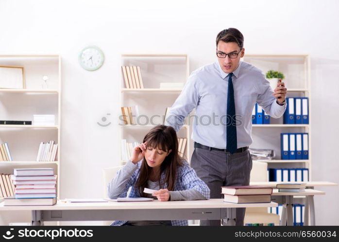 Male lecturer giving lecture to female student