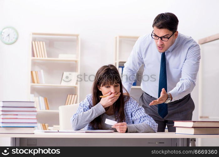 Male lecturer giving lecture to female student