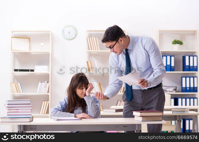 Male lecturer giving lecture to female student