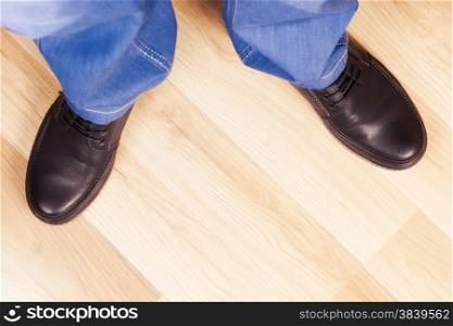 male legs in jeans and shoes in interior