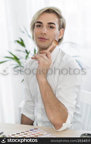 male make up look holding brush