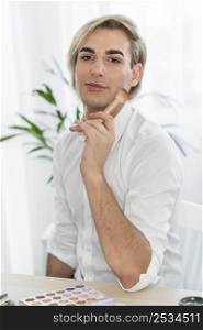male make up look holding brush