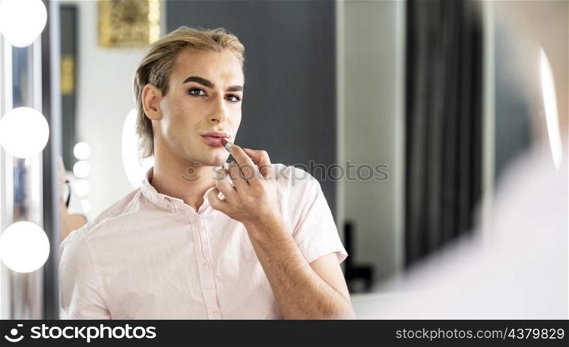male make up look looking mirror