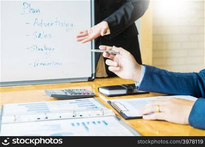 Male manager expressing ideas on whiteboard meeting talk to Strategy planning about financial growth, Business team meeting present concept