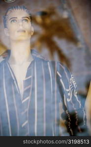 Male mannequin behind a glass window