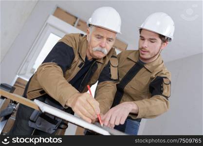 male manual workers marking materials