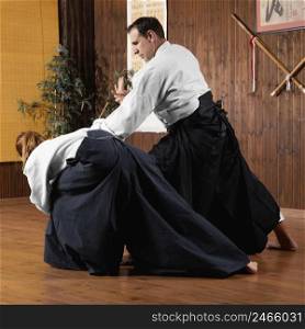 male martial arts instructor training practice hall with trainee