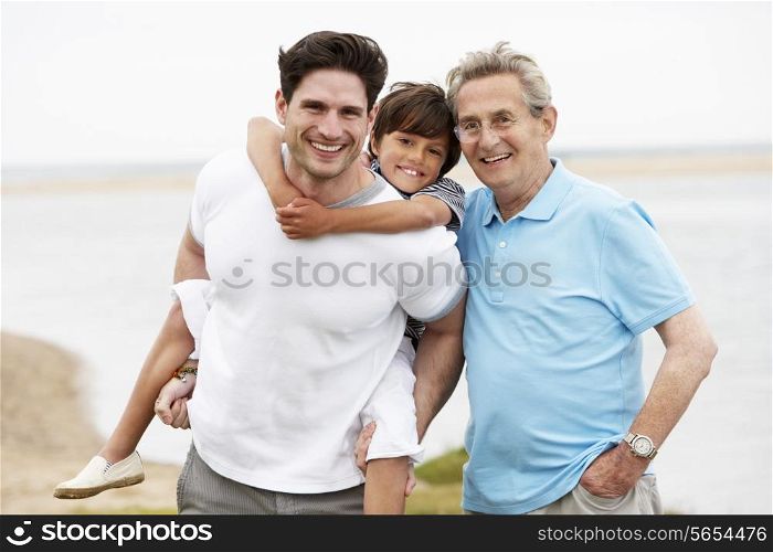 Male Members Of Multi Generation Family Standing By Sea