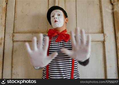 Male mime artist, gesture scene, parody comedy. Pantomime theater, comedian, positive emotion, humour performance, funny face mimic and grimace. Male mime artist, gesture scene, parody comedy
