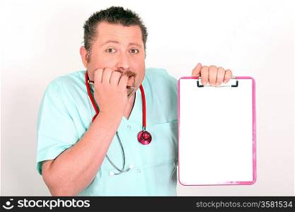 Male nurse looking scared holding notepad