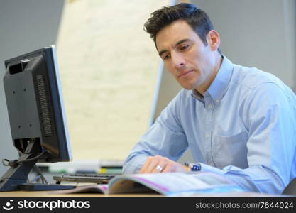 male office worker drinking coffee and thinking